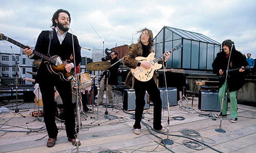 The Beatles performing on the rooftop of their central London offices; January 30, 1969. Original source: Parker Otto Film Productions, parkerottofilmproductions.com/reviews/the-beatles-get-back-review.